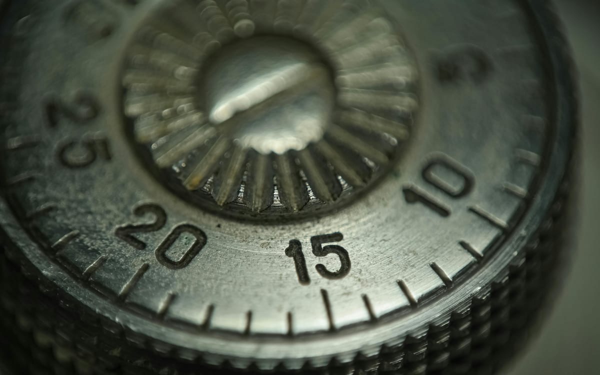 Combination dial lock on a residential safe showing chrome mechanism detail